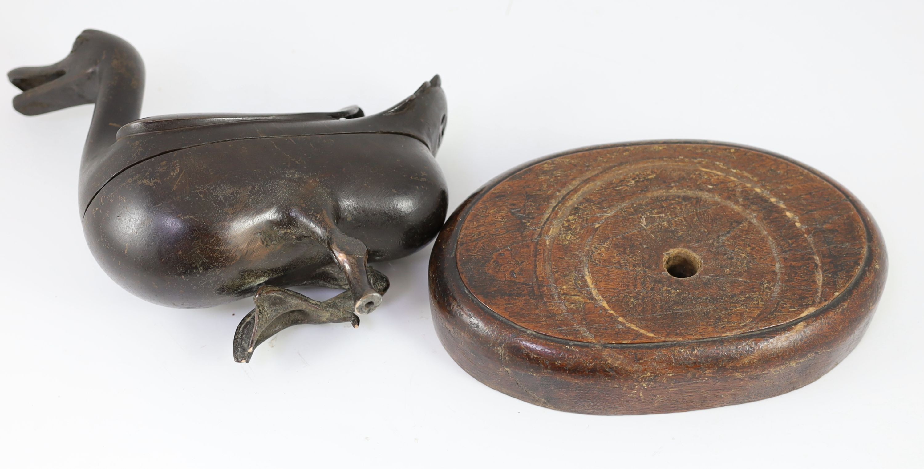 A Chinese Ming bronze ‘duck’ censer and cover, 17th century, 24.5cm long, missing one foot and later inset wood stand